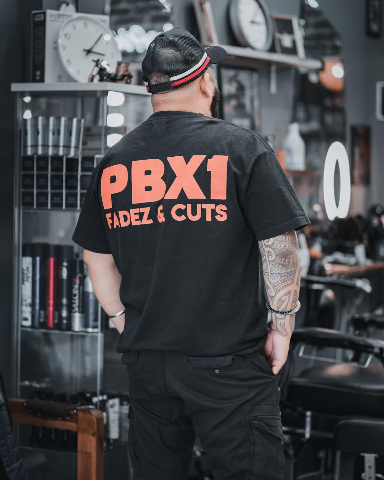 A PBX1 barber in the branded Fadez and Cuts tee working in the Sydney shop