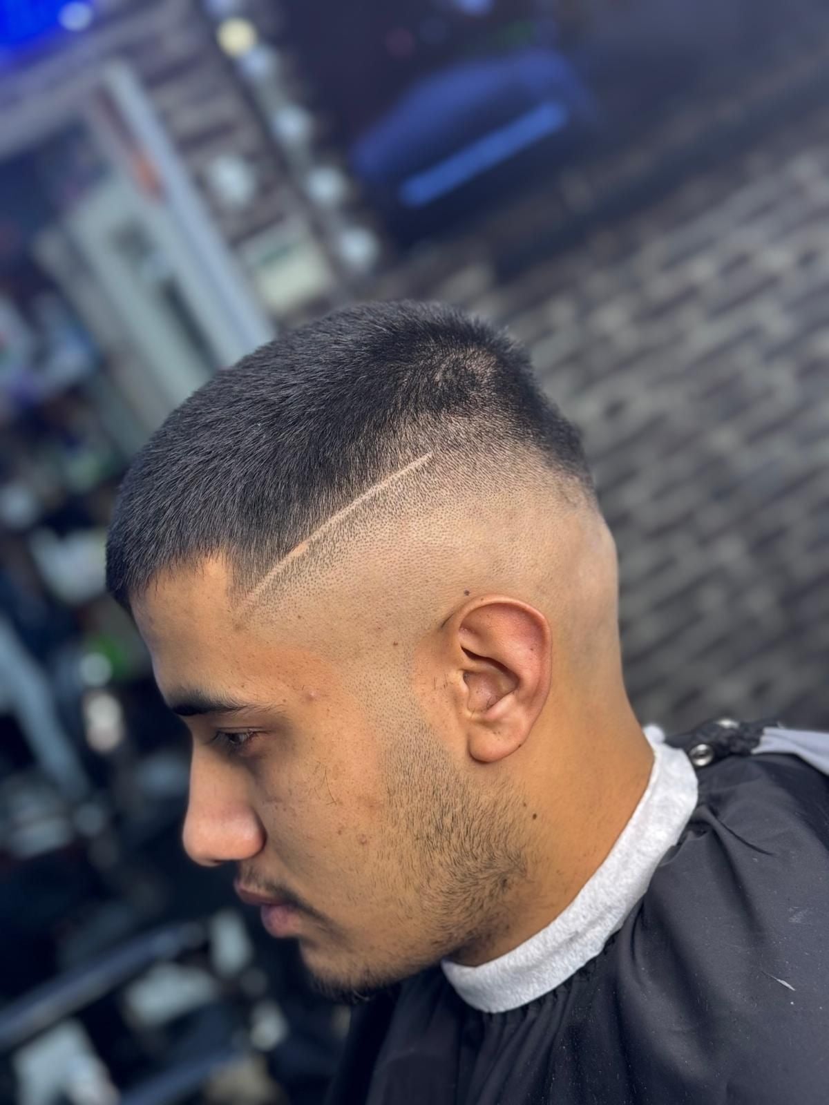 Side profile textured crop with a razor line and high skin fade
